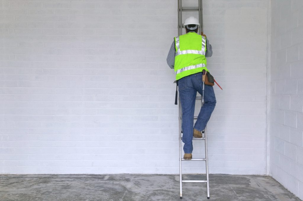 Workman climbing a ladder