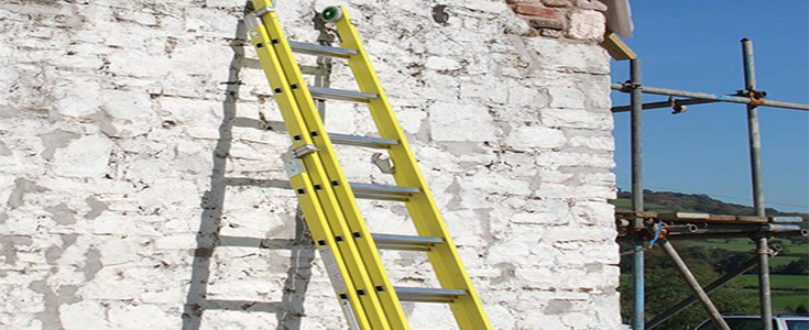 Fibreglass ladders against a stone wall