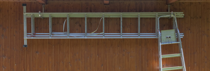 aliminium extension ladders hanging in garage