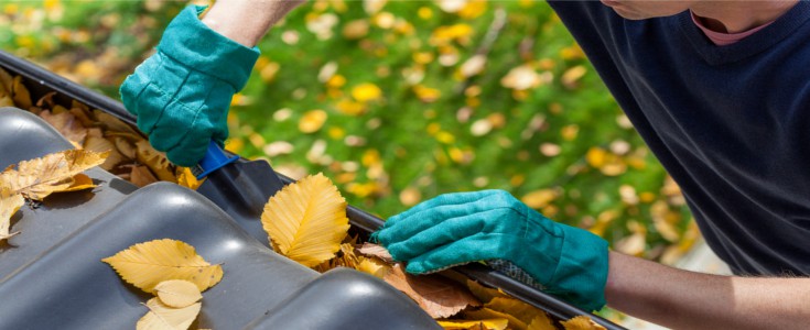 man with hands cleaning gutters